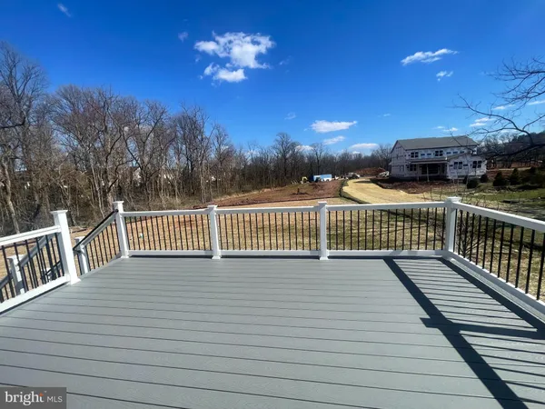 a view of a balcony with wooden floor and fence