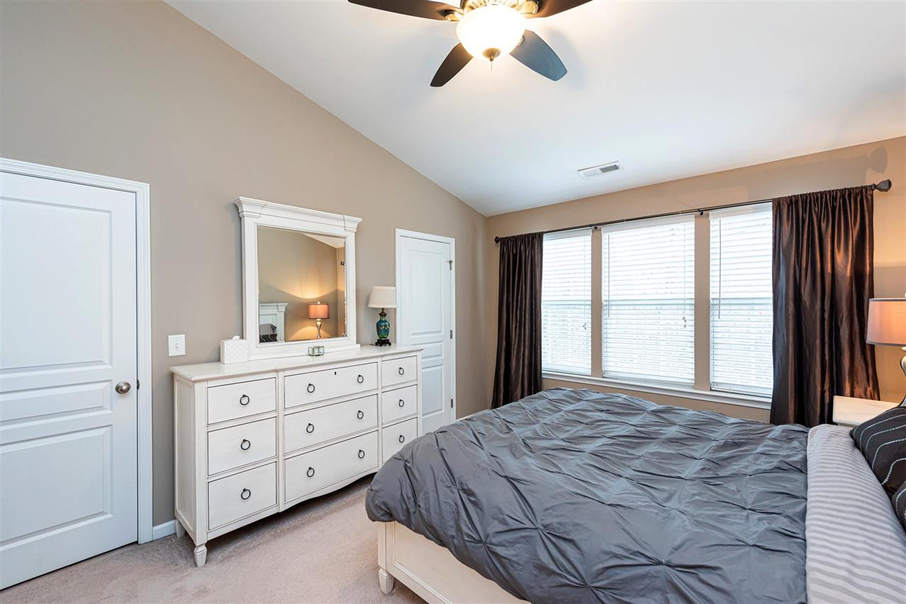 7749 Winners Edge Street Raleigh, NC 27617 - Photo 11 of 29 Doors on either side of the dresser lead to the HIS and HERs Master Closets. Master Bedroom