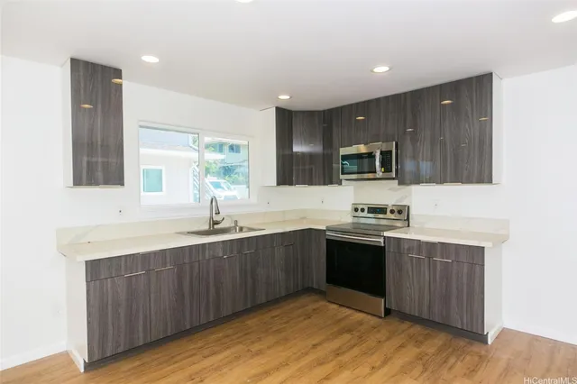 a kitchen with stainless steel appliances granite countertop wooden cabinets a sink and dishwasher