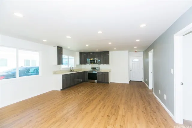 a large kitchen with a lot of counter space and a refrigerator