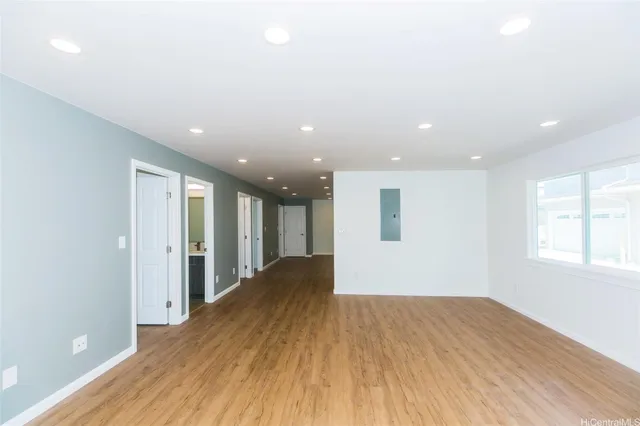a view of a big room with wooden floor and natural light