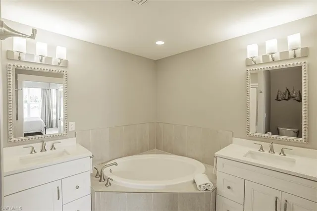a bathroom with a sink and a mirror with bathtub