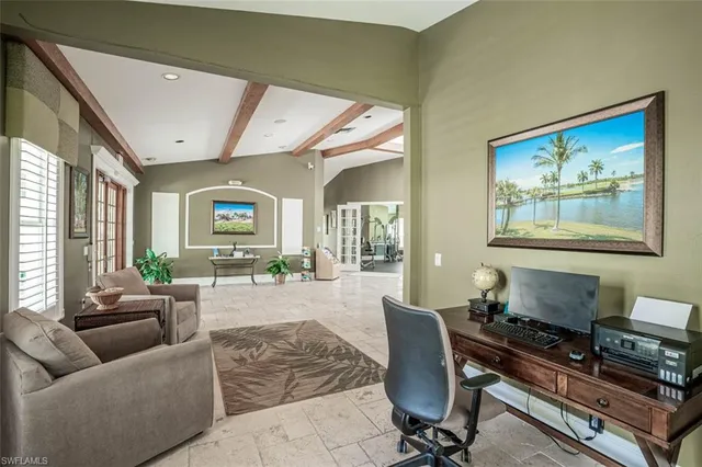 a living room with furniture a flat screen tv and a large window