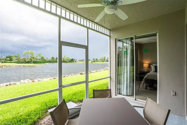a bedroom with a bed and a large window with outer view