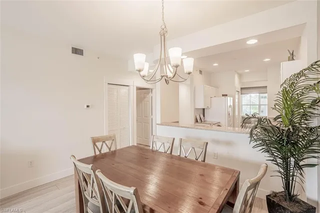a view of a dining room with furniture and a chandelier