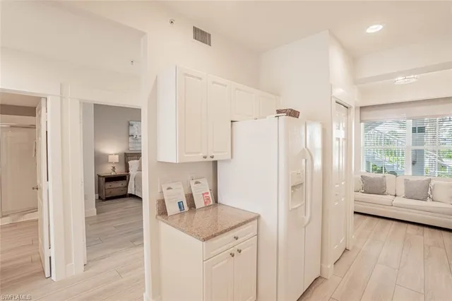 a view of kitchen with furniture and refrigerator