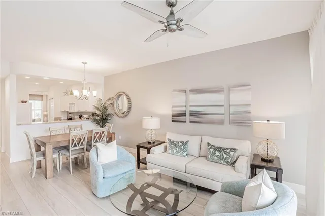 a living room with furniture a rug and white walls