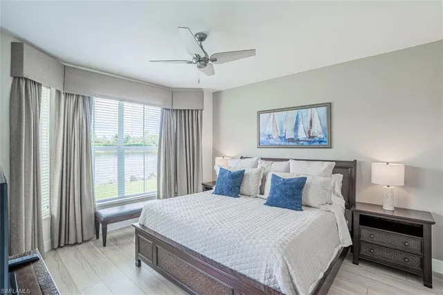 a bedroom with a large bed and a chandelier