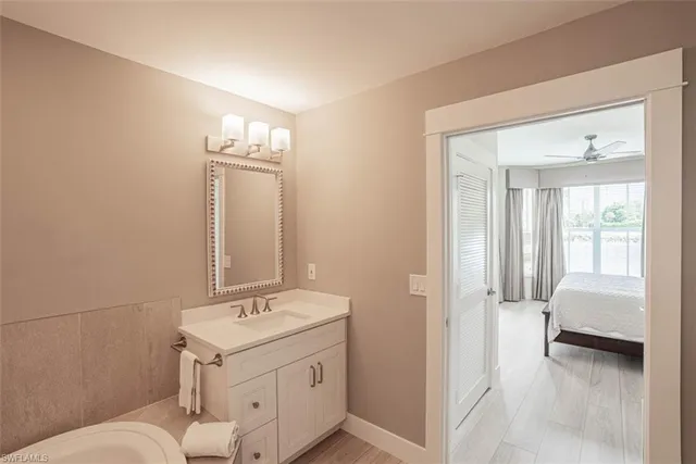 a en suite bathroom with a sink and a mirror