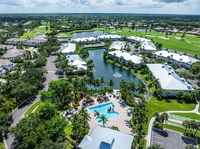 an aerial view of residential houses with outdoor space and river