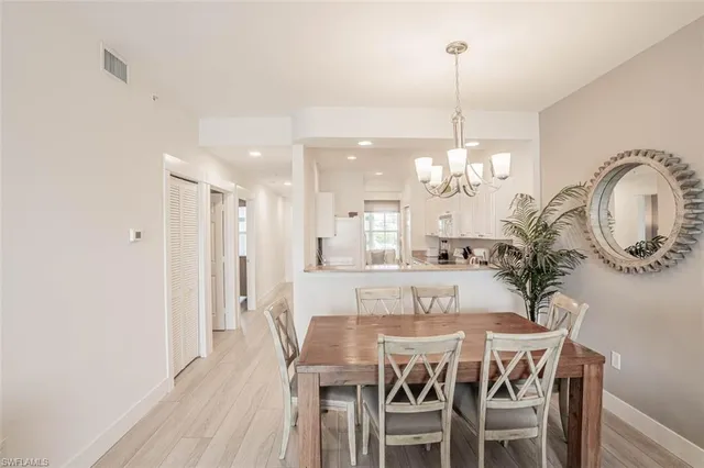 a view of a dining room with furniture and chandelier
