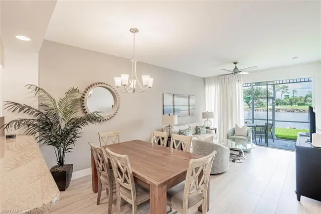 a living room with furniture a window and a chandelier