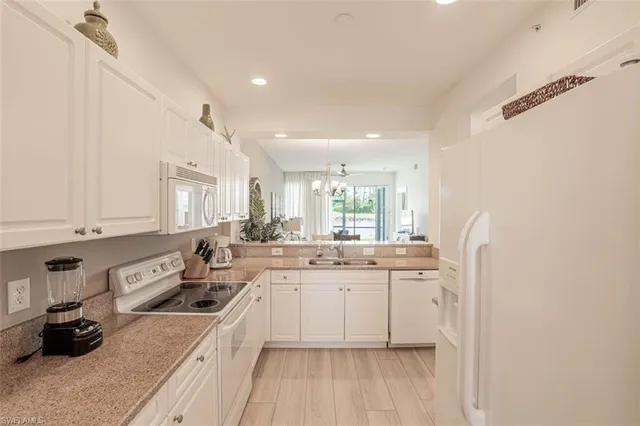 a kitchen with a sink a stove a refrigerator and cabinets