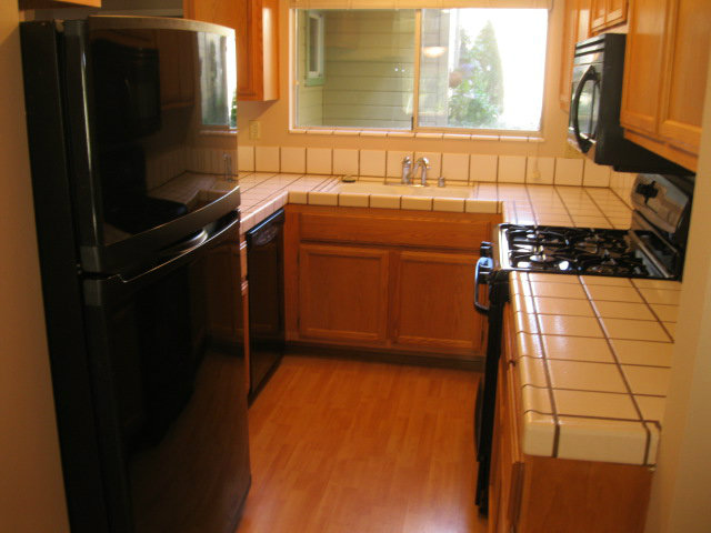 7246 Lotus Way Aptos, CA 95003 - Photo 5 of 17 a kitchen with a sink and a refrigerator