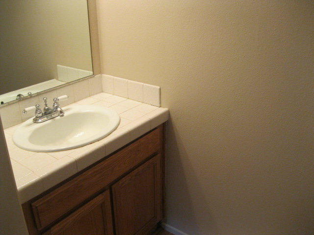7246 Lotus Way Aptos, CA 95003 - Photo 7 of 17 a bathroom with a sink and a mirror