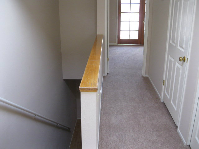 7246 Lotus Way Aptos, CA 95003 - Photo 9 of 17 a view of a hallway with wooden floor and stairs