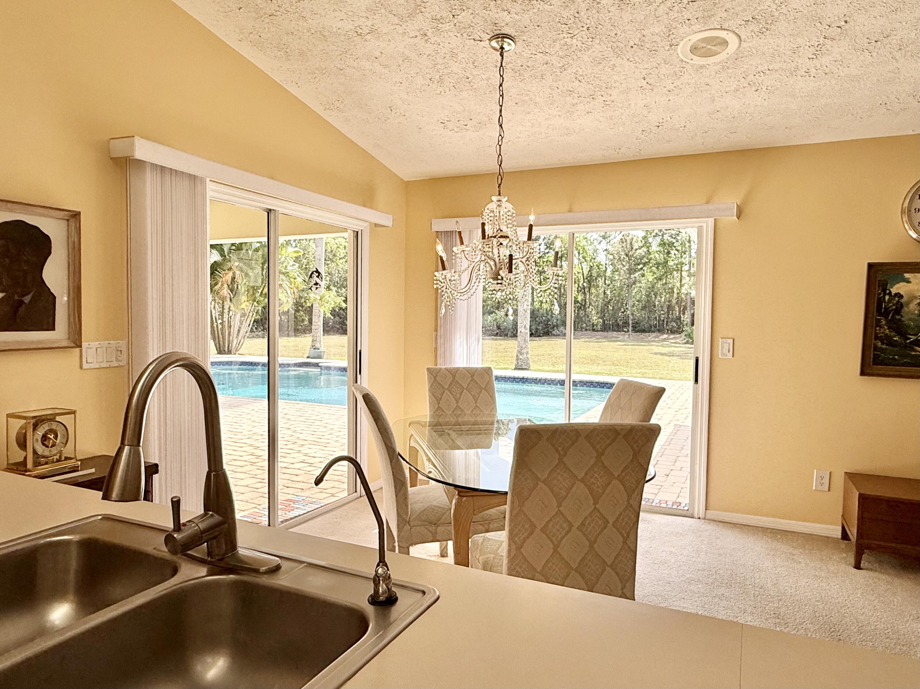 2884 Southeast Ranch Acres Circle Jupiter, FL 33478 - Photo 18 of 93 kitchen to pool
