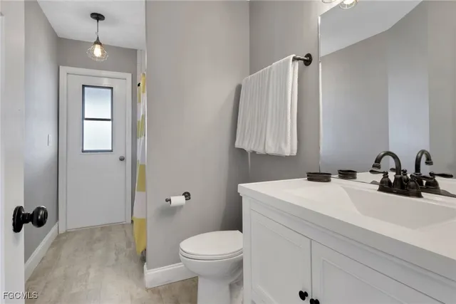 a bathroom with a sink toilet and mirror