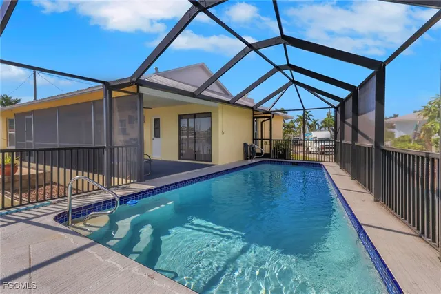 a view of a backyard with a small deck and wooden floor