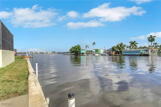 a view of a lake from a balcony with furniture