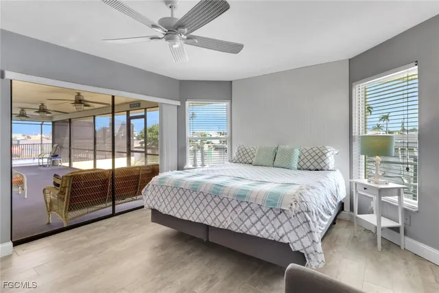 a bedroom with a large bed and a balcony view