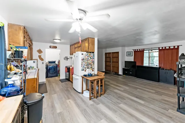a living room with lots of furniture and wooden floors