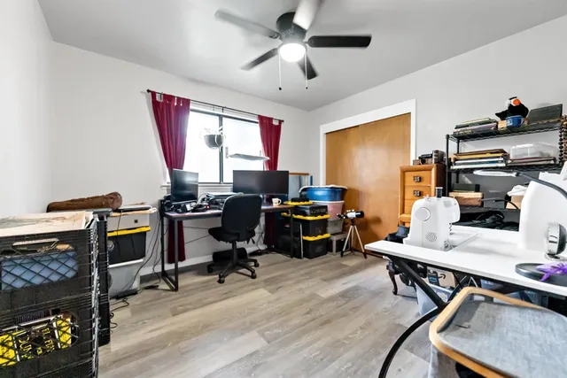 a view of a workspace with furniture and a window