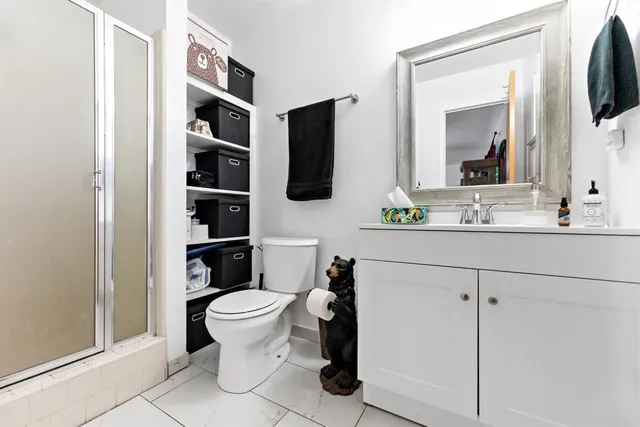a bathroom with a toilet sink and mirror