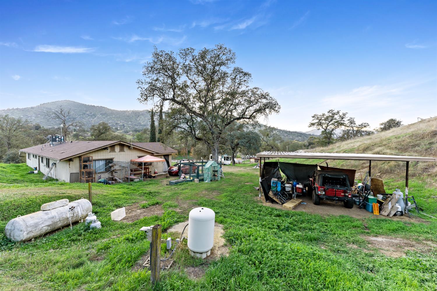 37000 Sand Creek Road Squaw Valley, CA 93675 - Photo 19 of 20 a view of a house with backyard sitting area and garden