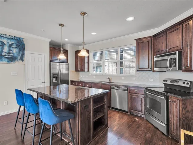 a kitchen with a stove a sink and a refrigerator