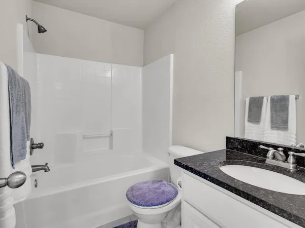 a kitchen with stainless steel appliances granite countertop a stove and a wooden floor