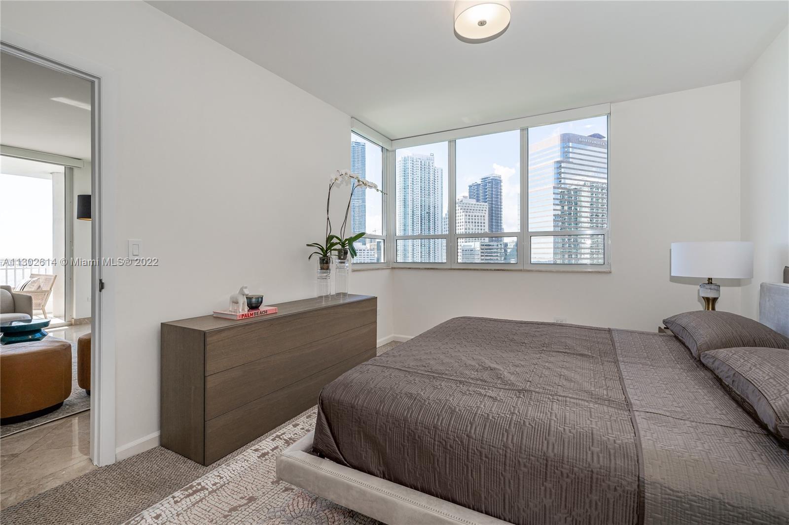 801 Brickell Key Boulevard, Unit 1701 Miami, FL 33131 - Photo 15 of 32 a bedroom with a bed and a dresser next to a window