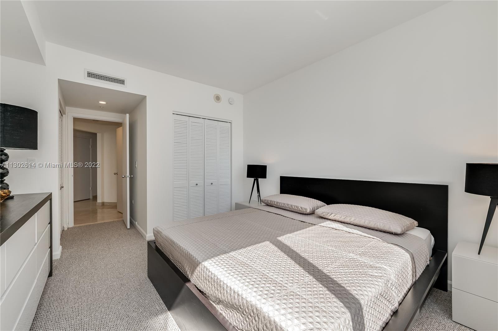 801 Brickell Key Boulevard, Unit 1701 Miami, FL 33131 - Photo 19 of 32 a bedroom with a bed and a flat screen tv