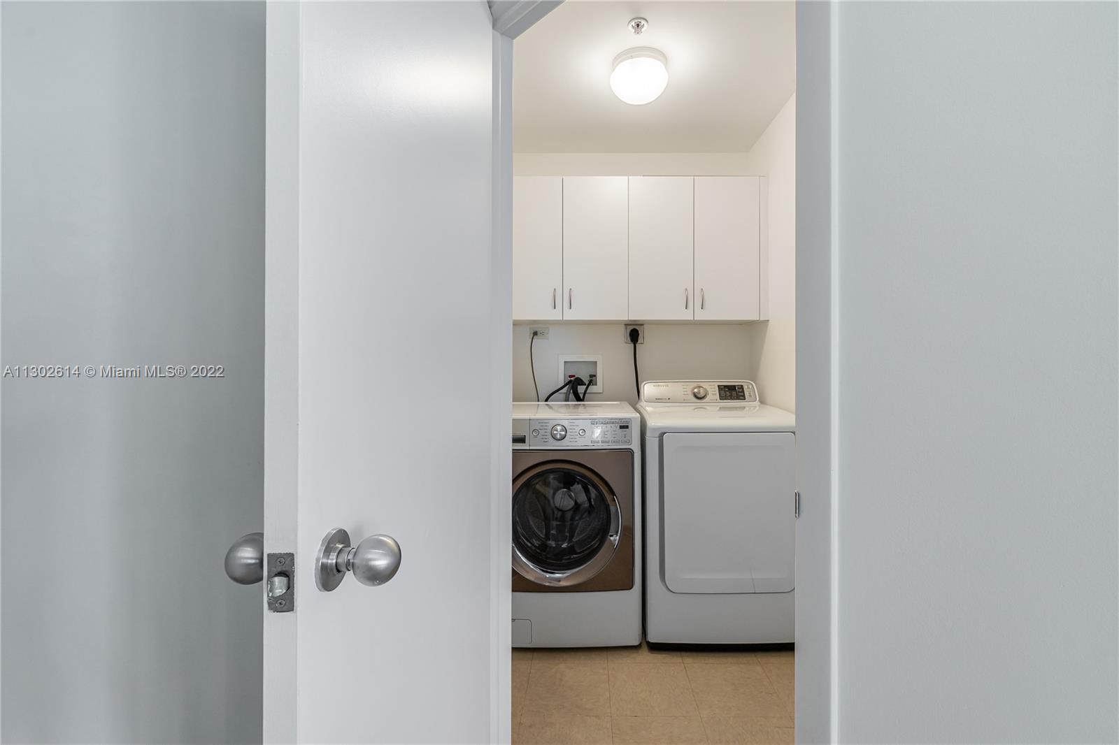 801 Brickell Key Boulevard, Unit 1701 Miami, FL 33131 - Photo 23 of 32 a utility room with sink dryer and washer