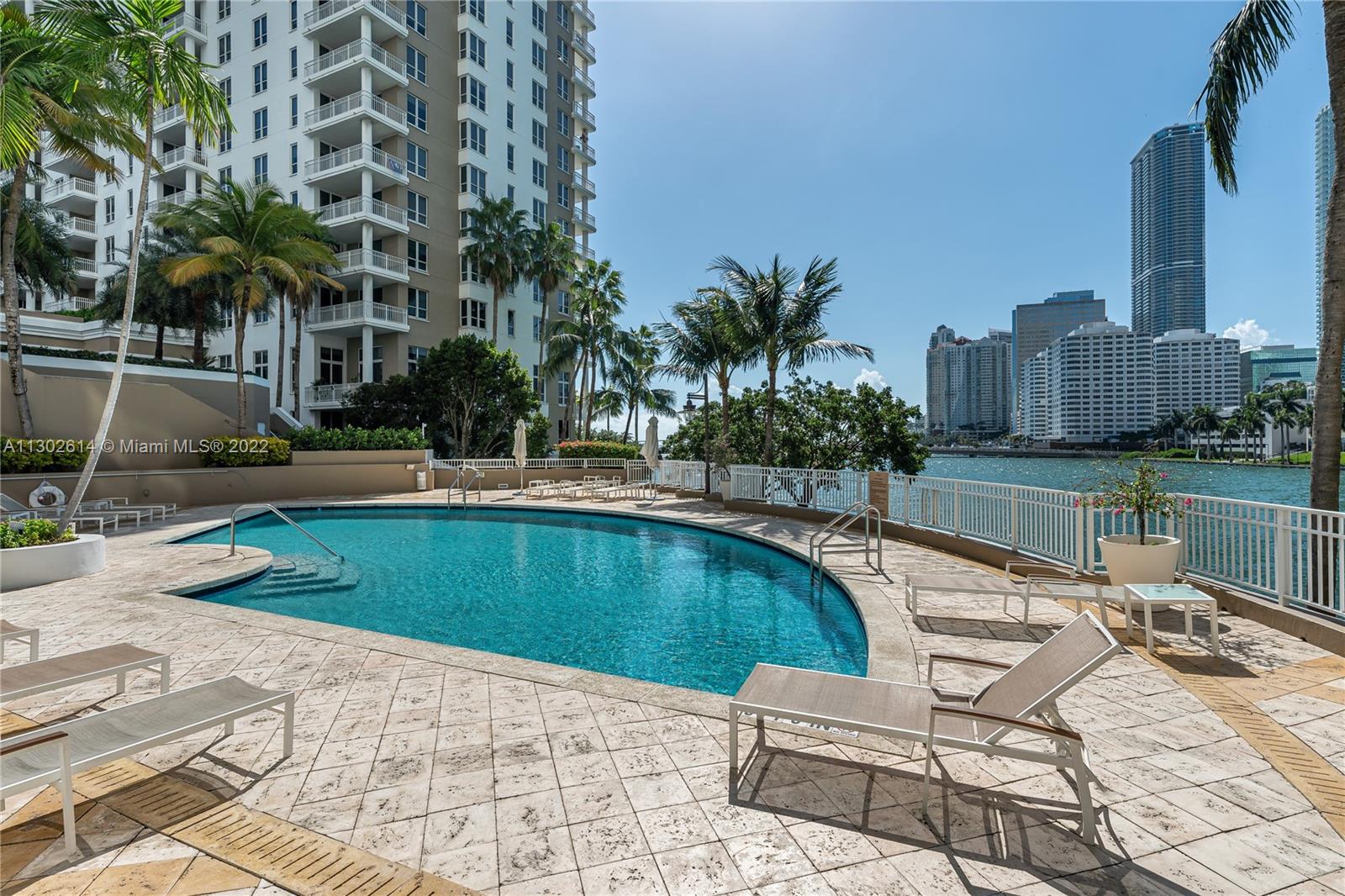801 Brickell Key Boulevard, Unit 1701 Miami, FL 33131 - Photo 25 of 32 a swimming pool with outdoor seating and yard