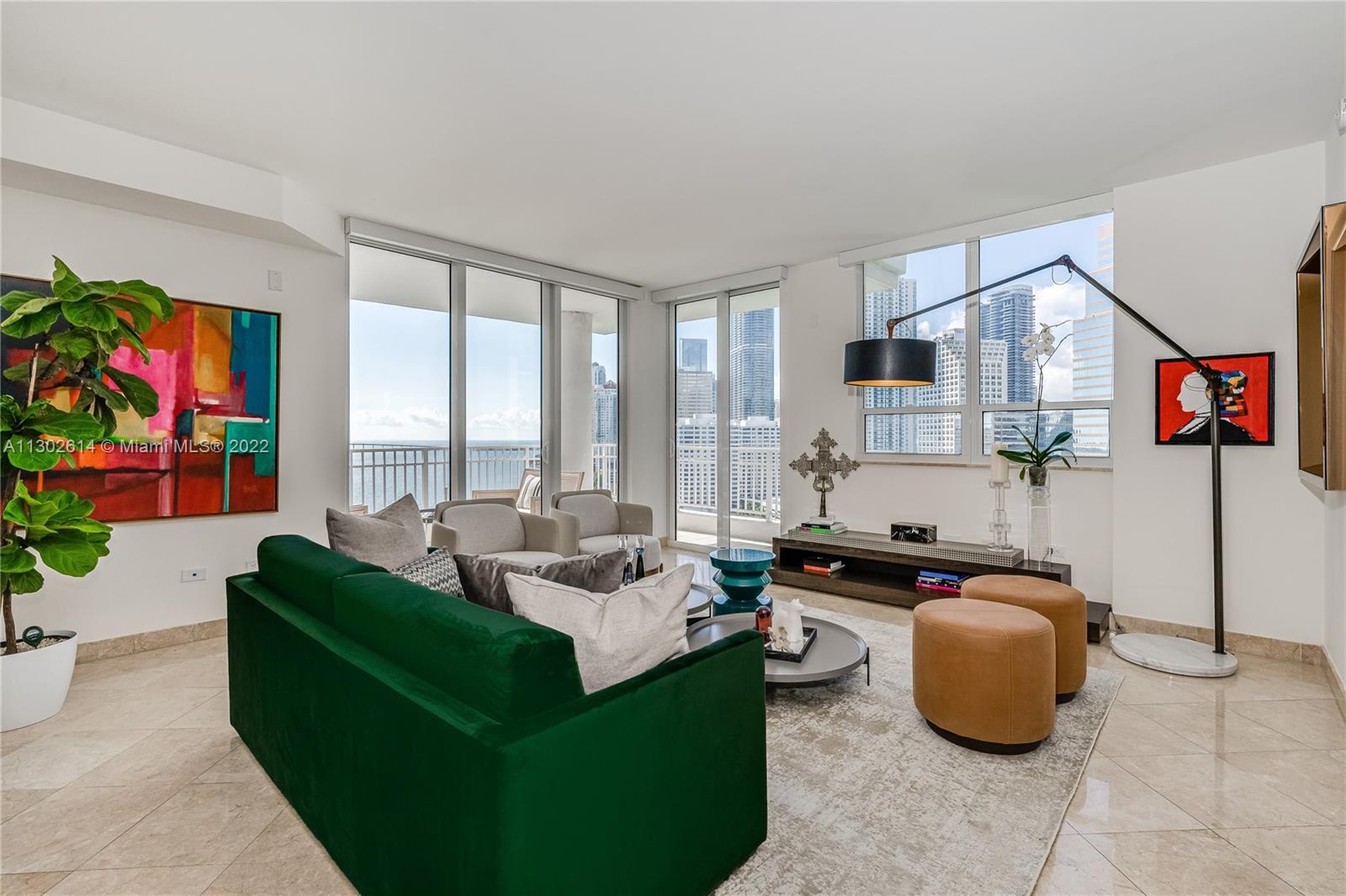 801 Brickell Key Boulevard, Unit 1701 Miami, FL 33131 - Photo 5 of 32 a living room with furniture and a flat screen tv