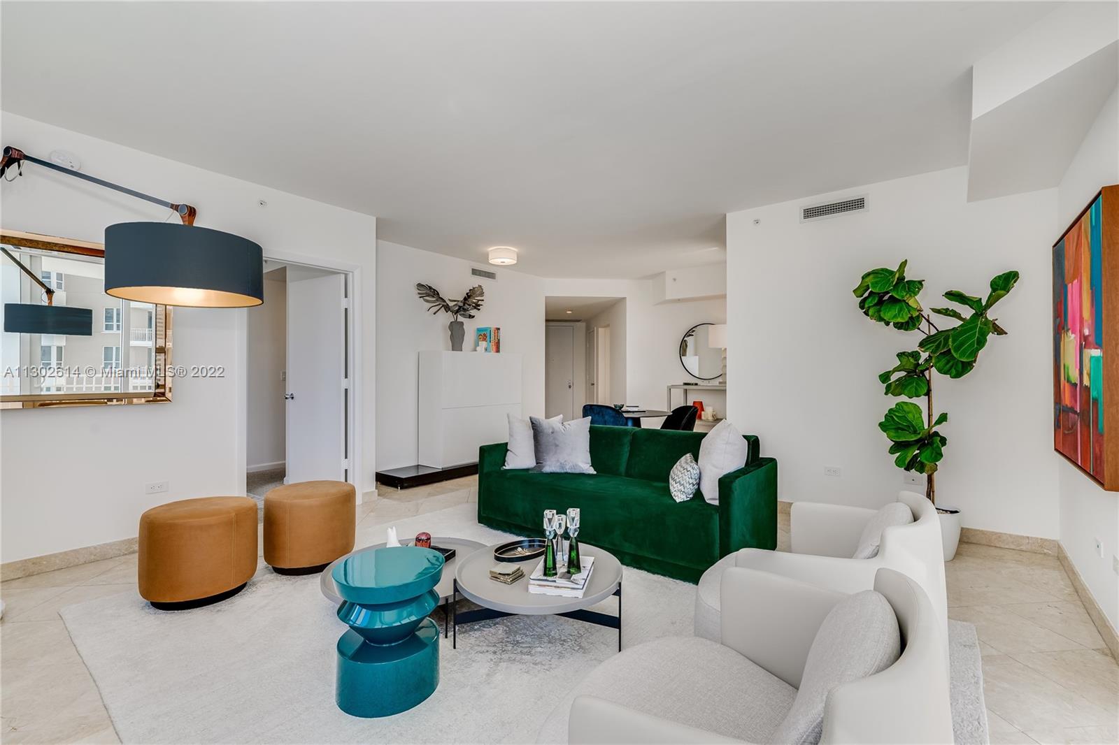 801 Brickell Key Boulevard, Unit 1701 Miami, FL 33131 - Photo 6 of 32 a living room with furniture and a potted plant