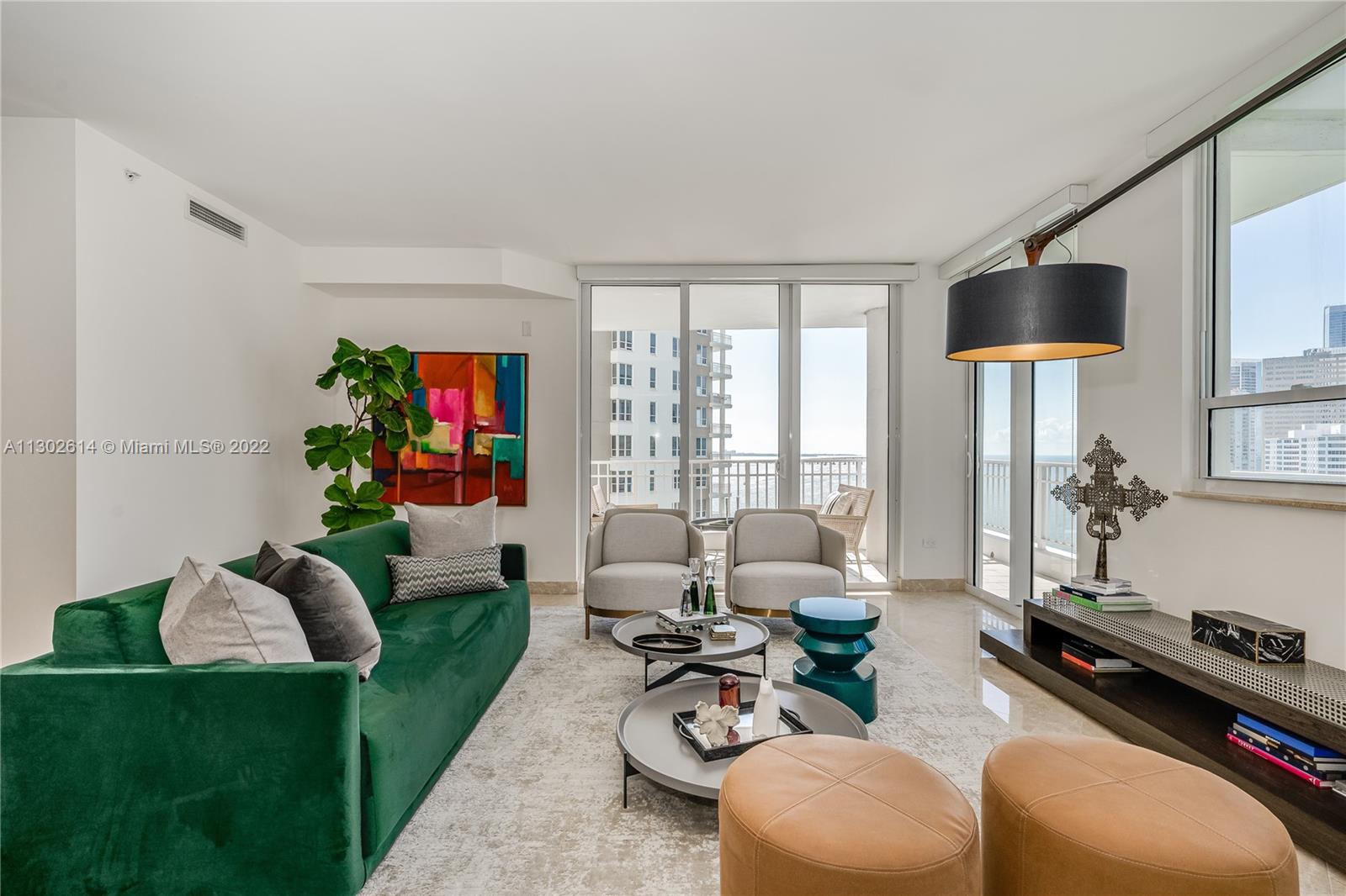 801 Brickell Key Boulevard, Unit 1701 Miami, FL 33131 - Photo 9 of 32 a living room with furniture rug and a large window