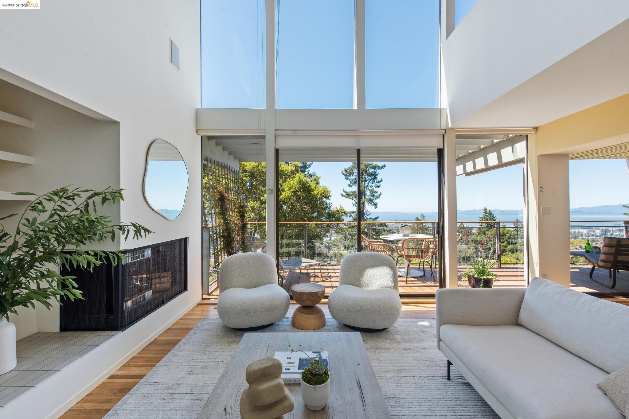 a living room with furniture fireplace and a large window