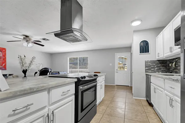a kitchen with stainless steel appliances granite countertop a stove and a sink