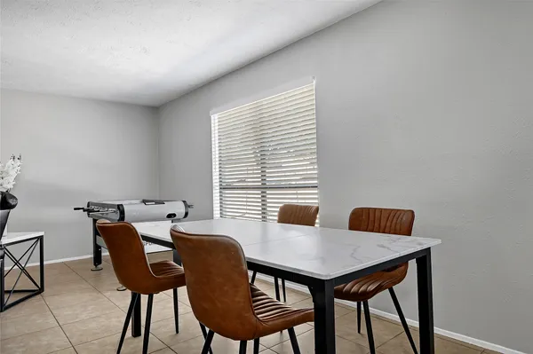 a view of a dining room with furniture and window