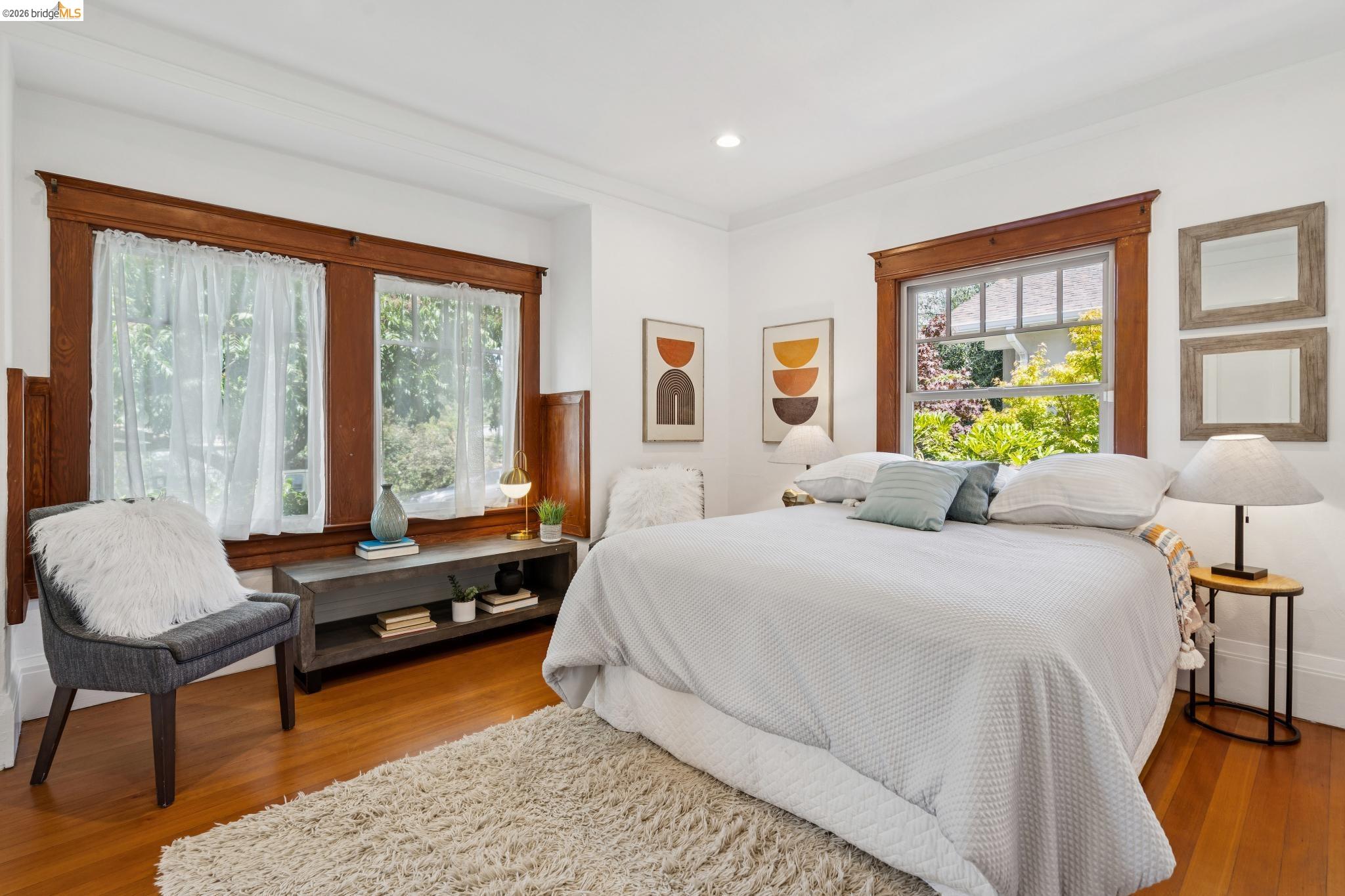 1701 Derby Street Berkeley, CA 94703 - Photo 23 of 39 Bedroom featuring rich wood-trim windows, bright white walls, and polished wood flooring