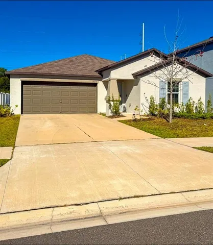 a front view of a house with a yard and garage