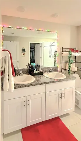 a bathroom with a sink vanity granite and a mirror