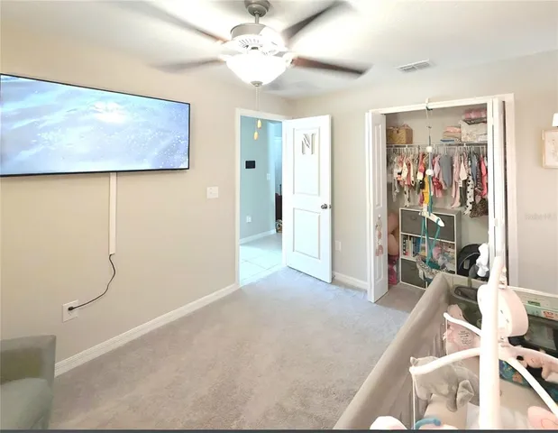 a view of a livingroom with furniture and a ceiling fan