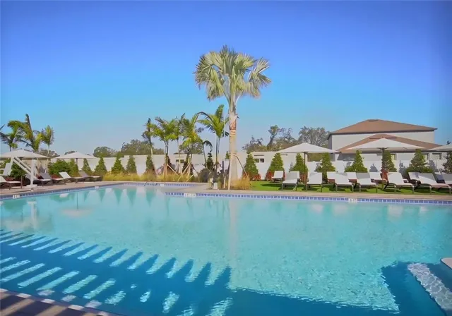 a view of swimming pool with outdoor seating