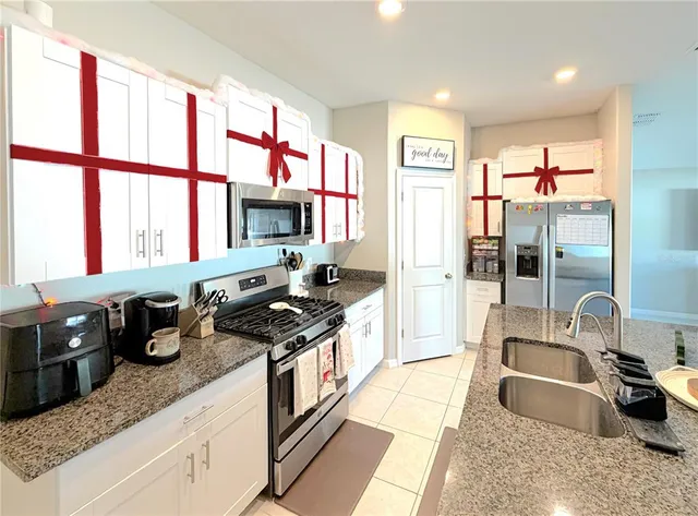 a kitchen with stainless steel appliances granite countertop a sink stove and a granite counter top