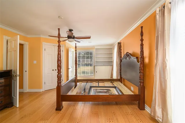 a view of a livingroom with wooden floor and a ceiling fan