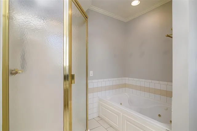 a bathroom with a tub and shower