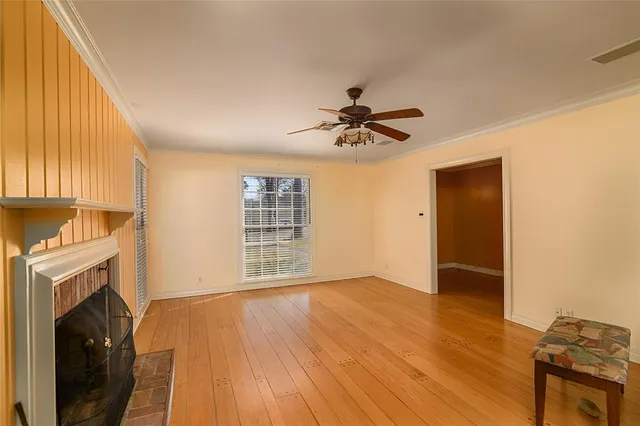 a view of an empty room with a fireplace and a window